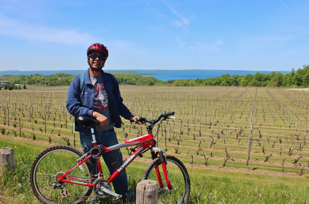 Bike riding on a sunny spring day through the vineyard on the Old Mission Peninsula in Michigan