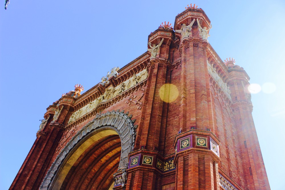 Red Arc de Triomf against blue skies in Barcelona, Spain