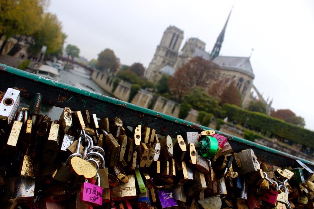 Paris, France. Locks of Love and Notre-Dame in the background on a fall day.