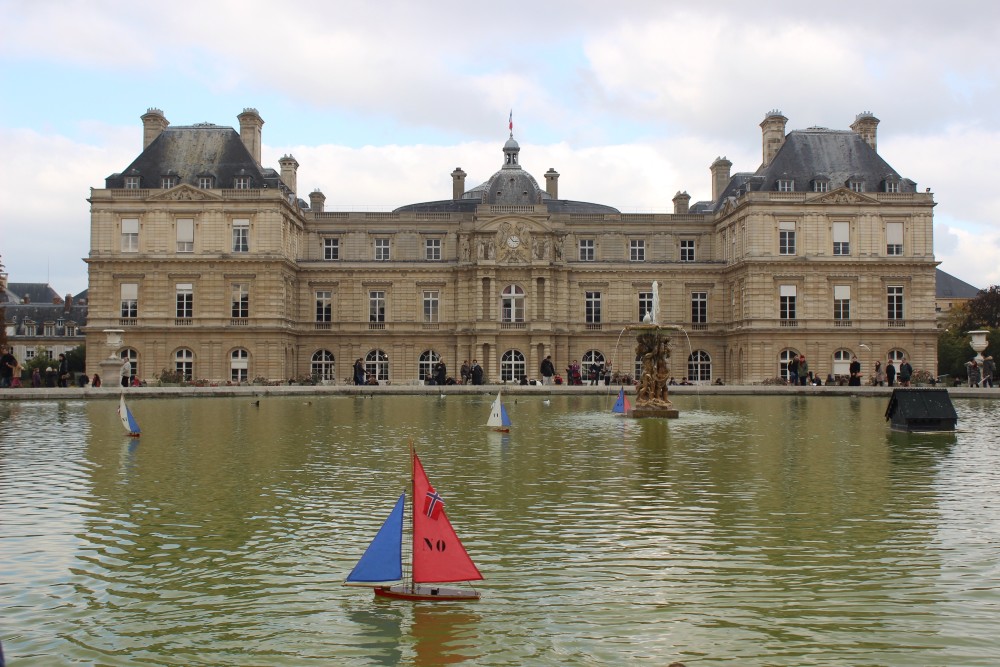 Fountain at the Luxembourg Gardens with a blue and red toy sailboat in Paris, France