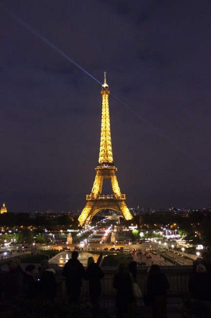The eiffel tower lit up at night in Paris, France