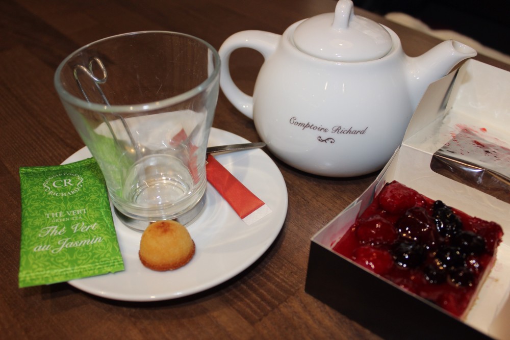 A white teapot with clear mug and berry treat in Paris, France