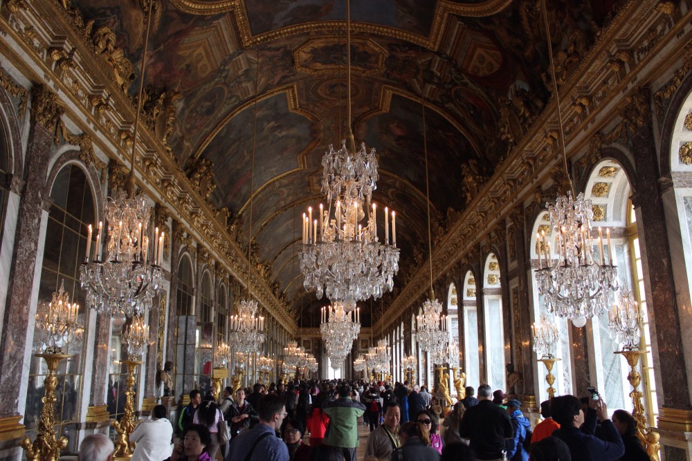 Crowded Hall of Mirrors with lots of chandeliers at the Palace of Versailles