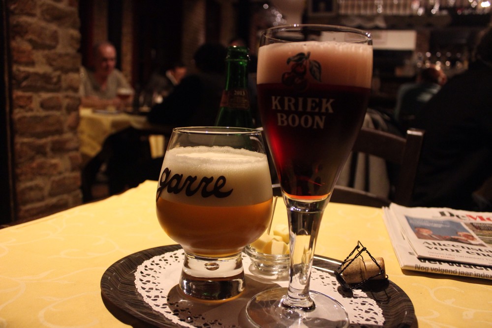 A glass of beer and a glass of raspberry lambic in an old bar in Bruges, Belgium