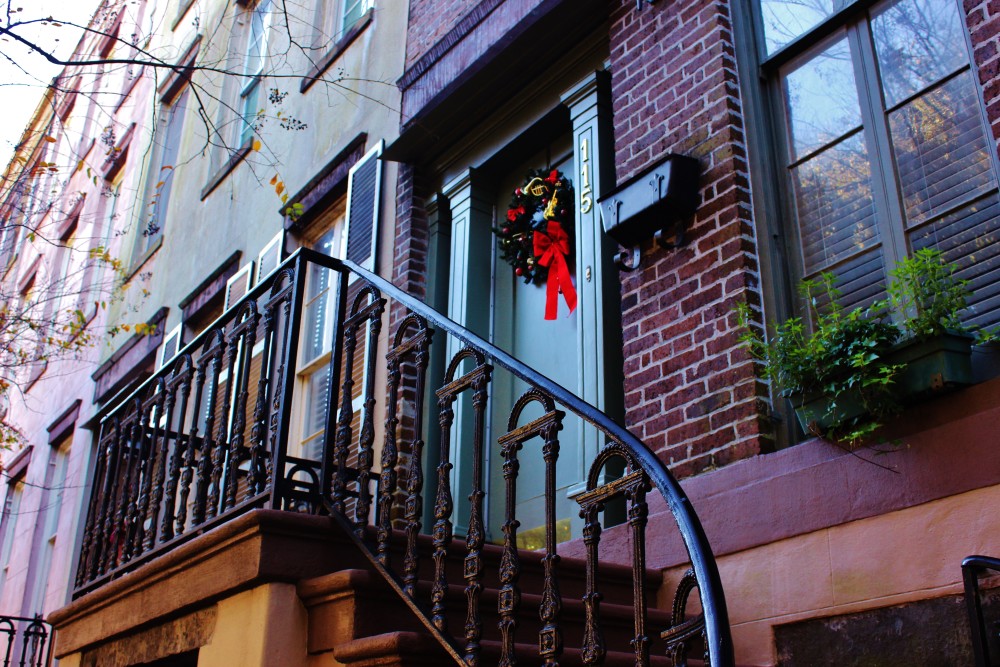Savannah. Old home with christmas wreath on door and wrought iron stair railing