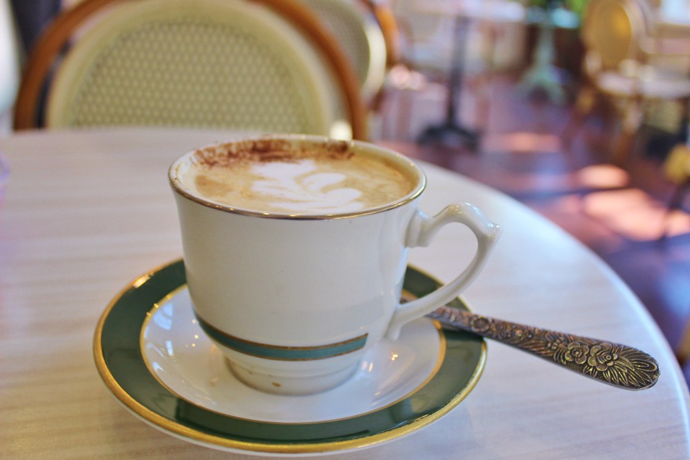 A pecan praline latte in fine china in a parisian cafe