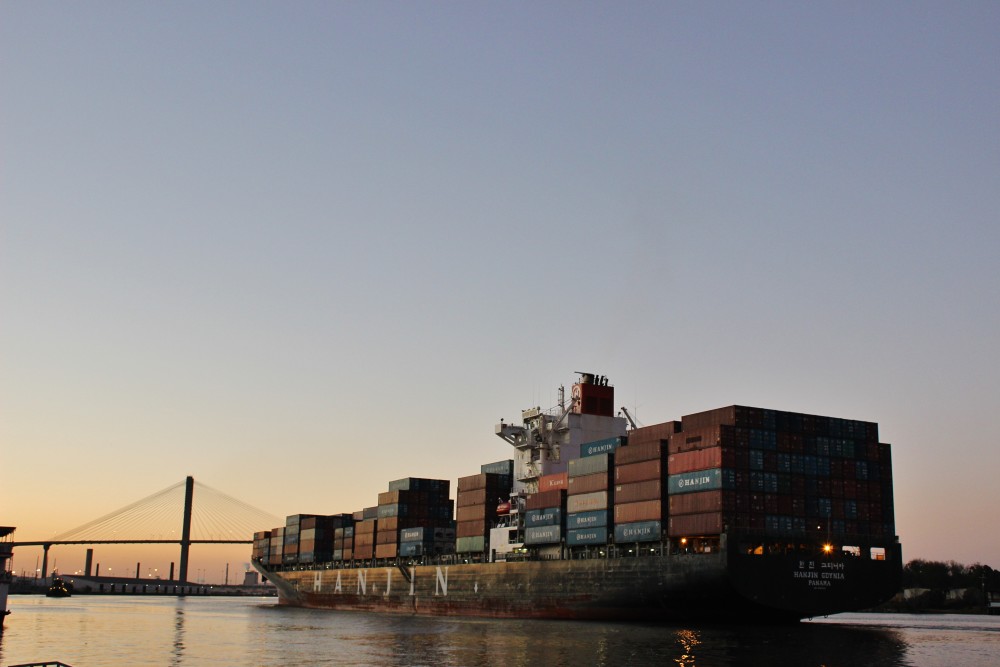 Savannah, GA. Large cargo ship sailing towards a bridge