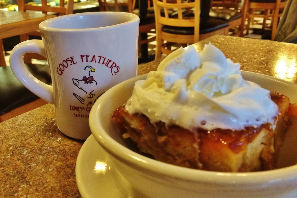 Goose Feathers. Bow of bread pudding topped with whipped cream and a cup of coffee.