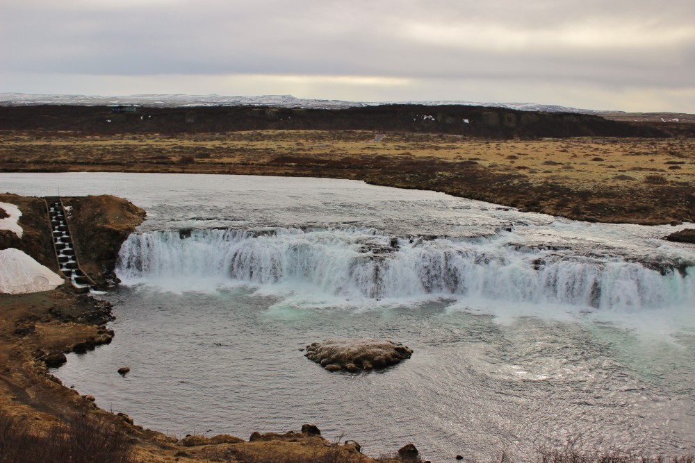 Faxi Falls with snow and ice and salmon ladder during the Golden Circle tour