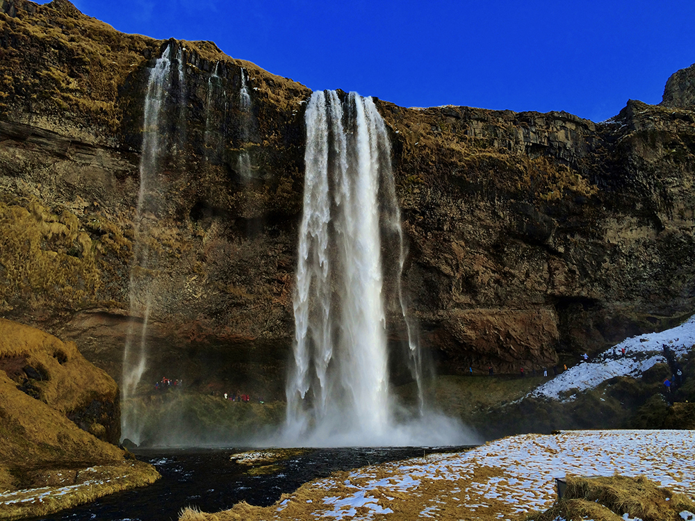 view of Seljalandsfoss with blue skies, Iceland's South Coast
