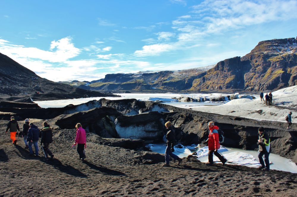 Ice climbers who just finished a hike at glacier Solheimajökull, Iceland's South Coast